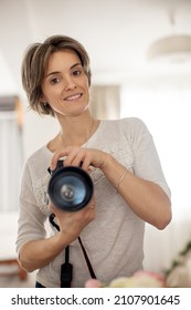 Attractive Young Woman Taking Picture Of Herself In The Mirror