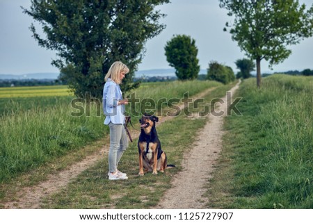 Similar – Attractive smiling blond woman with her two dogs