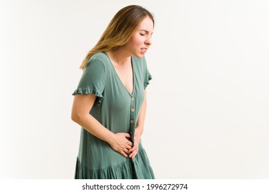 Attractive Young Woman Touching Her Lower Abdomen While Suffering From Urinary Incontinence Or Bladder Infection