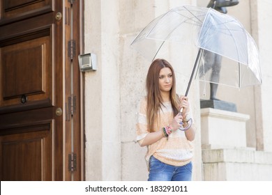 Attractive Young Woman With Umbrella Leaving Her House.