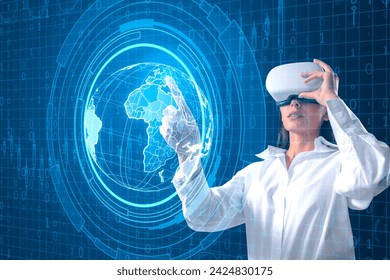 Attractive young woman with VR glasses using holographic screen with digital globe interface and business chart on blurry blue background. HUD, international stock and future monitor concept - Powered by Shutterstock