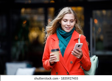 Attractive Young Woman Walking Outdoors, Using Mobile Phone, Texting, Tapping And Scrolling On Mobile Phone