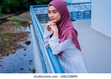 Attractive young woman wearing hijab walking on street.Beautiful Muslim girl wearing hijab.Muslim Hijab Fashion Portraiture.