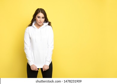 Attractive young woman in a white hoodie. Mock-up.