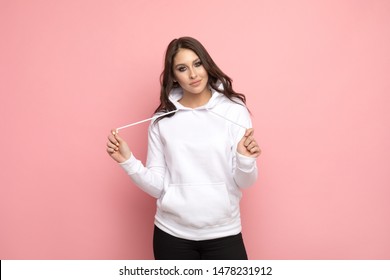 Attractive young woman in a white hoodie. Mock-up.