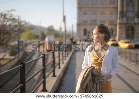 Similar – Woman Walking Through Building