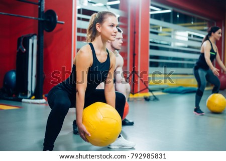 Attractive young women exercising with pilates ball at gym. The concept of a healthy lifestyle