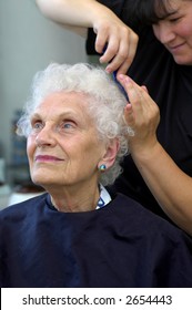 Attractivr Senior Getting Her Hair Styled At A Beauty Salon.