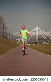 Attratcive Guy Is Running On His Trail While Warming Up His Body Before Training