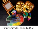 Attributes of the arts. Painting, theater. Canvas, palette, brushes, paints. Masks of tragedy and comedy.