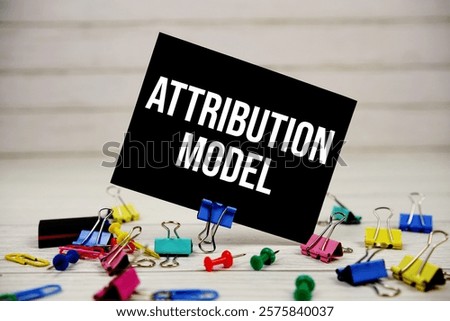 Attribution Model text on paper card with stationary on wooden background