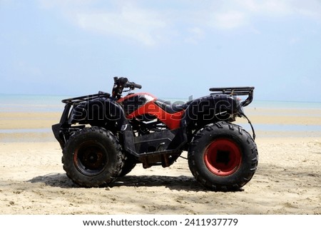ATV motorbike parked on the beach. Vehicles rented by beach visitors, these vehicles are used for tourists' enjoyment.