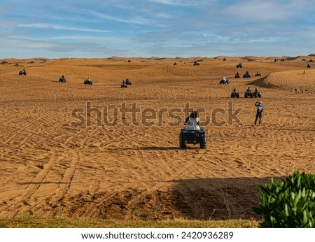ATV racing on sand dunes in the Rub al-Khali desert