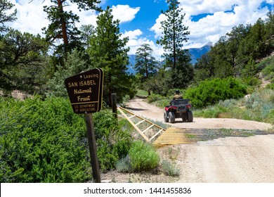 ATV Rider Crossed Cattle Guard As He Is Leaving The San Isabel National Forest In The Rocky Mountains Of Colorado, USA