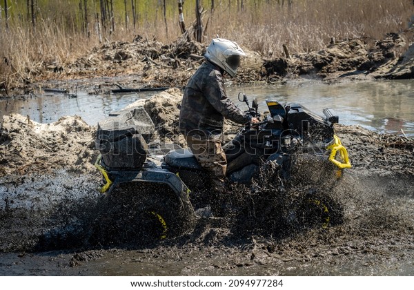 ATV and UTV in action in water track\
with water mud splash. Extreme competition.\
4x4.