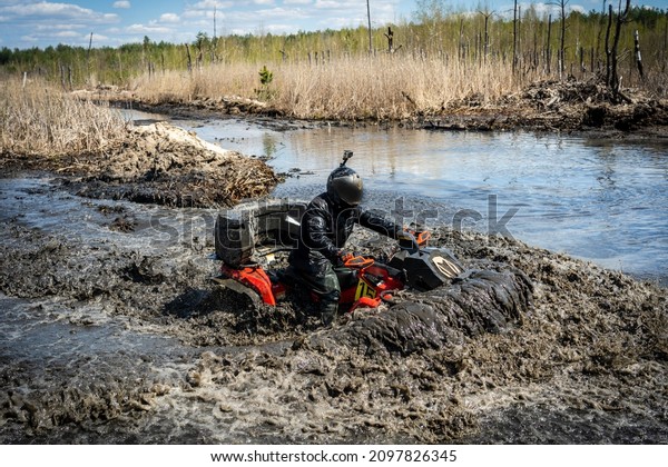 ATV and UTV in action in water track\
with water mud splash. Extreme competition.\
4x4.
