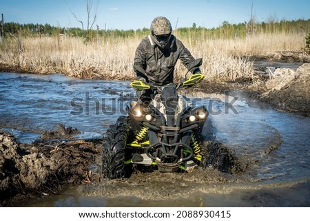 ATV and UTV offroad vehicle racing in hard track with mud splash. Amateur competitions. 4x4.