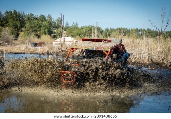 ATV and UTV riding in hard track with\
huge mud splash. Amateur competitions.\
4x4