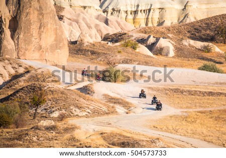 ATV vehicle in wild valley in Cappadocia, Turkey -  surrounded among the rocks, dunes and hills in Goreme National Park