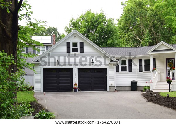 ATWO CAR GARAGE with doors painted in black in a\
residential house
