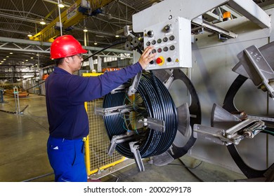 Atyrau, Kazakhstan - May 21,2012: Chevron Factory. Plastic Pipe Production Line. Young Asian Worker In Red Hardhat Controls Process.