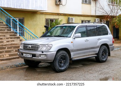 Atyrau, Kazakhstan - October 21, 2022: Grey Offroad Car Toyota Land Cruiser 100 In The City Street.