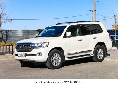 Atyrau, Kazakhstan - October 9, 2022: White Offroad Car Toyota Land Cruiser 200 In The City Street.