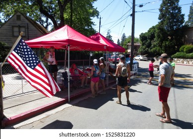 Auburn, California / USA - May 23 2015: Runners training for the Western States 100 Mile run arrive at an aid station in Auburn during a training camp, with race direction Craig Thornley waiting. 