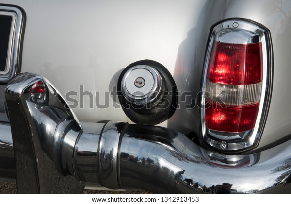 AUCH, FRANCE - MARCH 10, 2019 : The old cars :\
close-up of the rear of an ancient french car. Chromium covers\
taillight, gas cap top,and rear\
bumper.