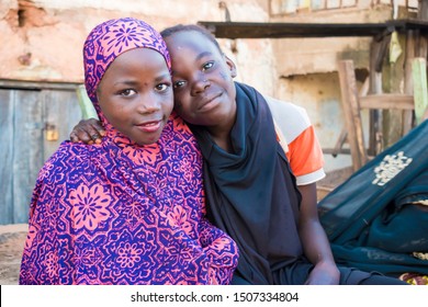 AUCHI, EDO / NIGERIA - September 7, 2019: homeless Hausa  children sitting outside begging for Money .