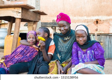 AUCHI, EDO / NIGERIA - September 7, 2019: Homeless Hausa  Family Sitting Outside Begging In The Street In Auchi Edo State