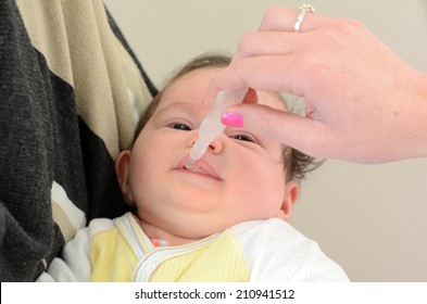 AUCKLAND - AUG 14 2014:Nurse Giving Newborn Baby Rotavirus Vaccine Immunization.It Protects Children From Rotaviruses, Which Are The Leading Cause Of Severe Diarrhea Among Infants And Young Children