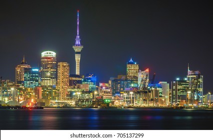 Auckland city skyline at night with city center and Auckland Sky Tower, the iconic landmark of Auckland, New Zealand.