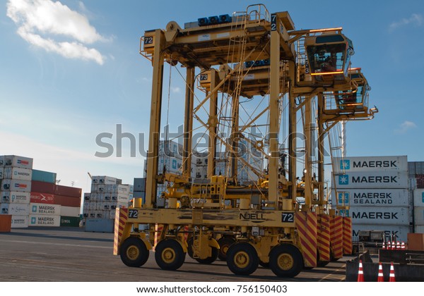 AUCKLAND, NEW ZEALAND - 17th APRIL\
2012: 3 straddle carriers and stack of containers at\
port.