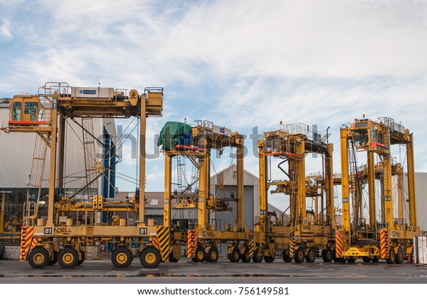 AUCKLAND, NEW\
ZEALAND - 2nd APRIL 2012: Four Noell straddle carriers and stack of\
containers at Auckland sea\
port.