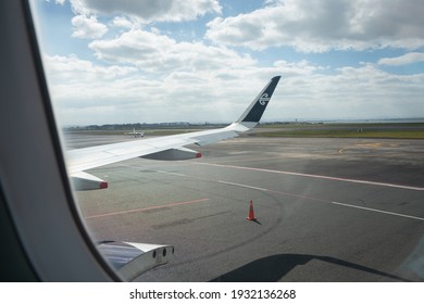 Auckland, New Zealand - December 18 2020: An Air New Zealand Flight At The Auckland Domestic Terminal With Cargo Door Open. Image Taken Inside The Airplane Sitting On The Window Seat.