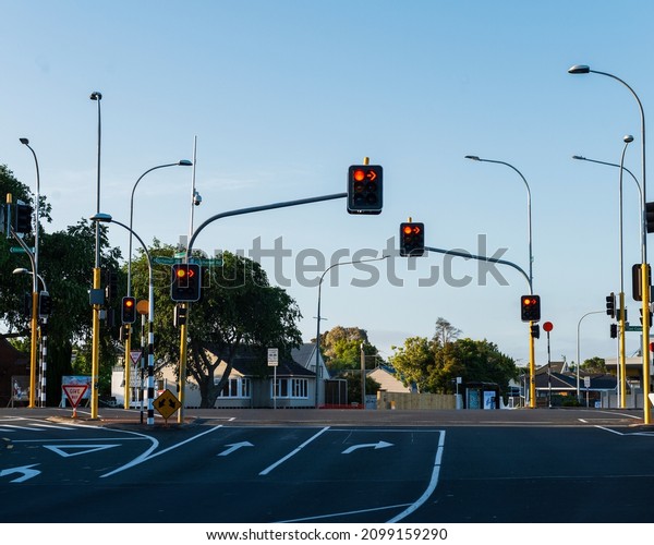 Auckland, New Zealand -\
December 25 2021: Empty streets with orange traffic lights,\
Milford, Auckland.