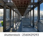 Auckland, New Zealand. The Gantry at Silo Park, Wynyard Quarter on the waterfront, a 100 metre long steel structure for the public to climb and take in the views. Auckland Harbour Bridge in distance.