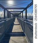 Auckland, New Zealand. The Gantry at Silo Park, Wynyard Quarter on the waterfront, a 100 metre long steel structure for the public to climb and take in the views. Auckland Harbour Bridge in distance.