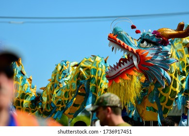 Auckland, New Zealand - Jan 2020. A Chinese Dragon Is Being Carried In The Street On Sticks;  Chinese New Year Celebration.