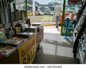 Auckland / New Zealand - January 6 2020: View Of Book Shop Interior And Entrance With Man Leaving Store