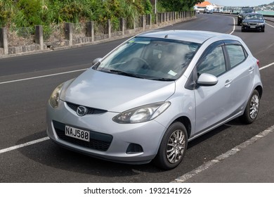 Auckland, New Zealand - March 7, 2021: View Of Gray Mazda Demio Car On Side Of Road