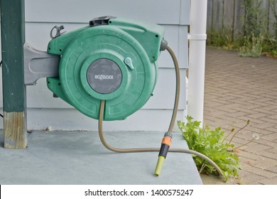 Auckland / New Zealand - May 18 2019: View Of Old Weathered Hozelock Retractable Garden Hose Reel