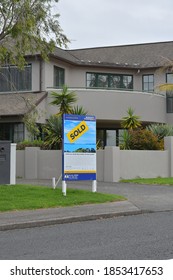 AUCKLAND, NEW ZEALAND - Nov 04, 2020: View Of Suburban House In Howick With Sold Sign On Cloudy Day