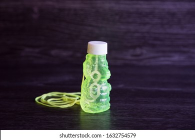 Auckland, New Zealand - October 2 2019: Plastic Teddy Bear Shaped Bubble Mixture Given As Party Favor For Kids. Fluro Yellow Green With String. Entertains Children For Hours. Not Environmentally Safe.