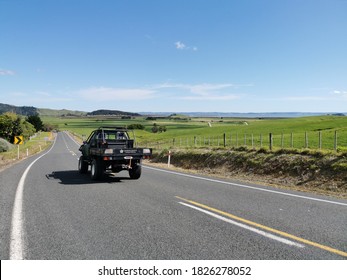 Auckland / New Zealand - October 3 2020: View Of Black Pickup Truck Driving Away On Rural Road