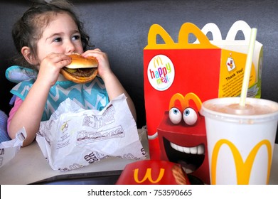 AUCKLAND - NOV 12 2017:Small Girl (Naomi Ben-Ari Age 03) Eats Fast Food. Fast Food Is Highly Processed And Contains Large Amounts Of Carbohydrates, Added Sugar, Unhealthy Fats, And Salt (sodium).