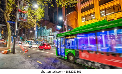 AUCKLAND, NZ - AUGUST 26, 2018: Downtown City Buildings And Bus Traffic At Night.