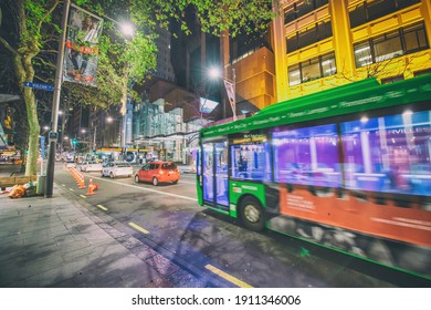 AUCKLAND, NZ - AUGUST 26, 2018: Downtown City Buildings And Bus Traffic At Night.