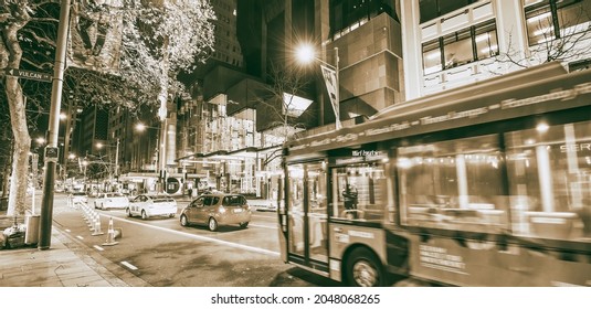 AUCKLAND, NZ - AUGUST 26, 2018: Downtown City Buildings And Bus Traffic At Night.